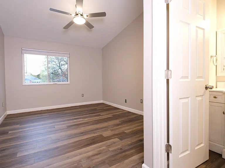 Master bedroom with entry to master bathroom.