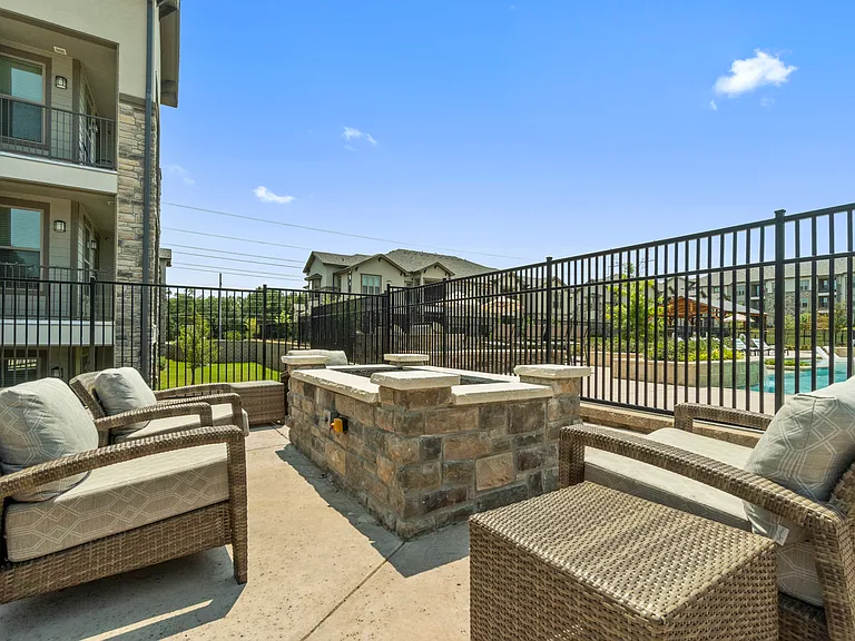 Gather with friends around the outdoor fireplace at Auberge of Tyler in Tyler, Texas.