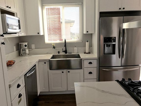 Kitchen- brand new stainless steel appliances, furnished with all cookware and serveware.