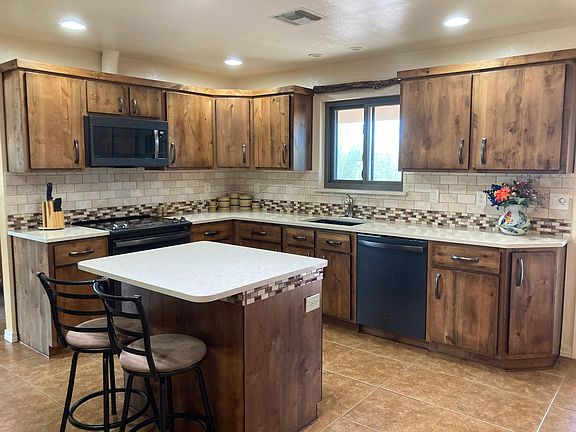 Alderwood cabinets & quartz counter tops.