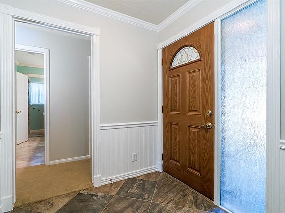 Bright entry with recent paint features beadboard and tile flooring.