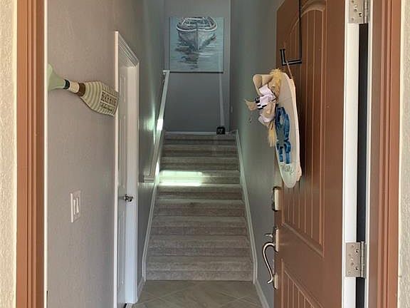 Hallway featuring light tile patterned flooring