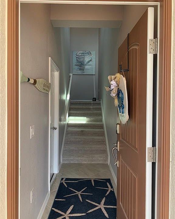 Hallway featuring light tile patterned flooring