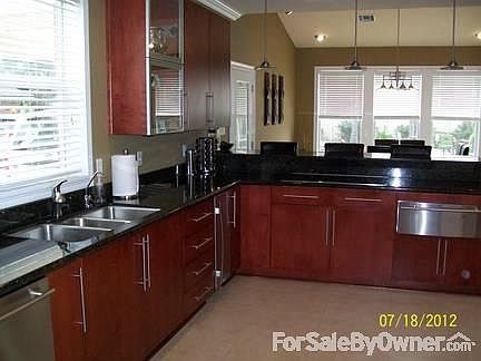 Kitchen w/ Separate Breakfast Area
						:
						custom kitchen w/ solid wood cabinets, S/S appliances & granite.