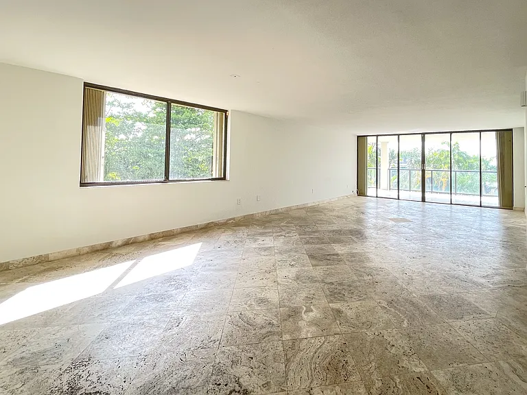 Sunlit dining and sitting areas - open concept with canopy views to the north and bay views to the East.