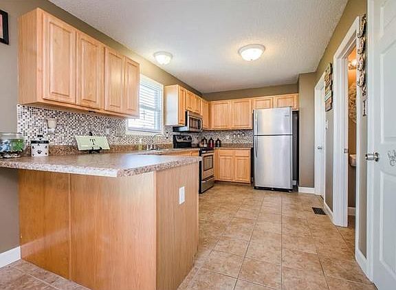 Wow! Fabulous kitchen has maple cabs, beautiful backsplash, new counters and stainless!