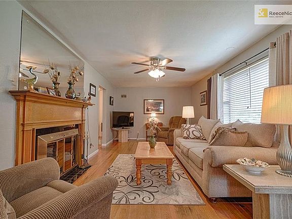 Light and bright living room with fireplace and large picture window. Hardwood floors throughout.