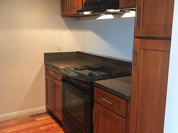 Another picture of wood floors and cabinets in the kitchen.