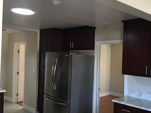 Lots of Kitchen counter space and stainless steel refrigerator.