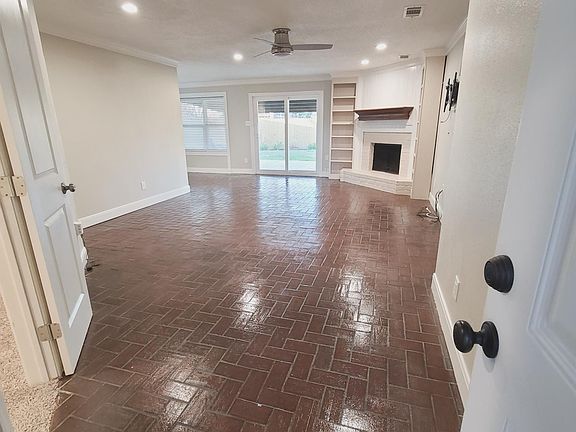 View from the front door into the living room. Storage closet/extra office to the left.