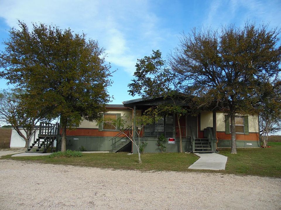 Front of home with storage unit to side
