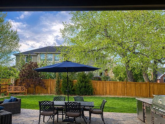 Outdoor Kitchen, dining and firepit with large seating area.