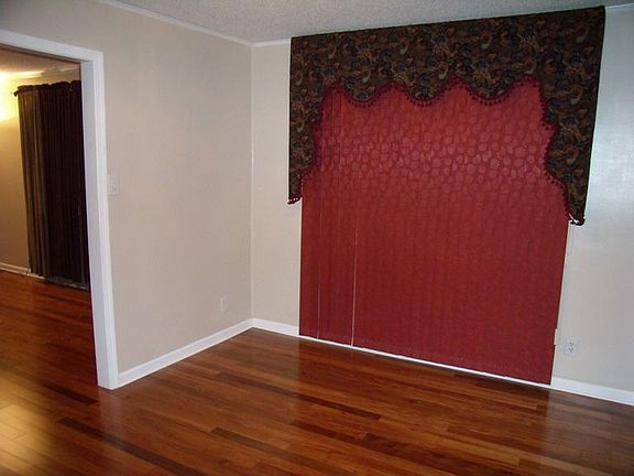 Dining room has hardwood floors and neutral colors