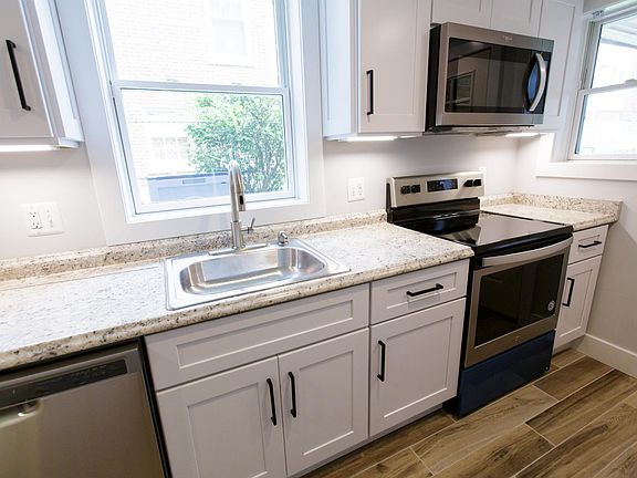 Two windows in kitchen for ample light. Undercounter lighting adds ambiance at night.