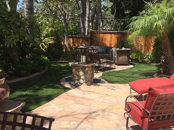 Right side of backyard with lots of seating and shade trees.