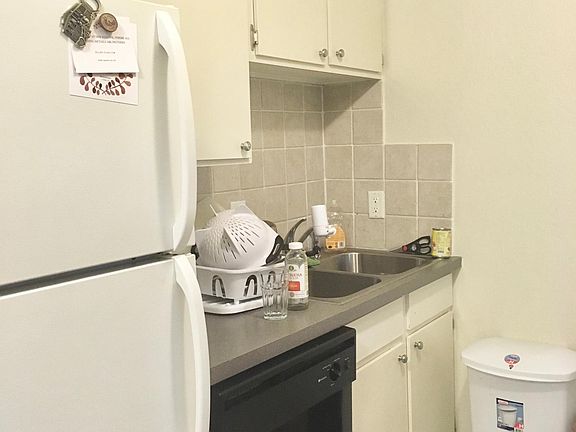 Kitchen with Dishwasher, double stainless sink and and Tile backsplash - 201