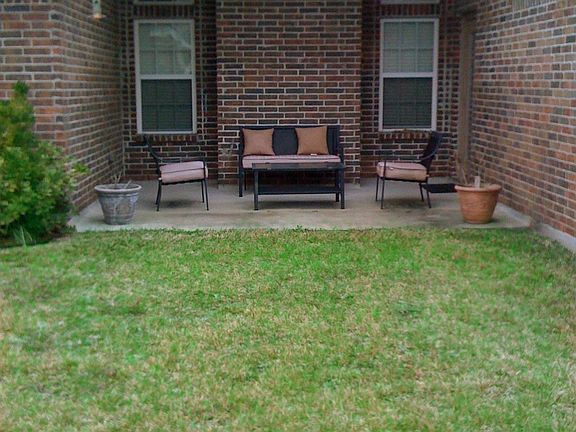 Covered patio for grilling or entertaining outdoors.