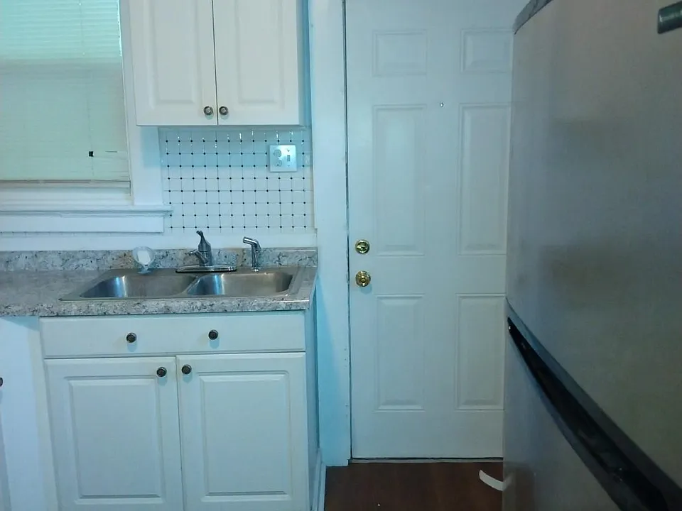 Kitchen with door leading to back yard