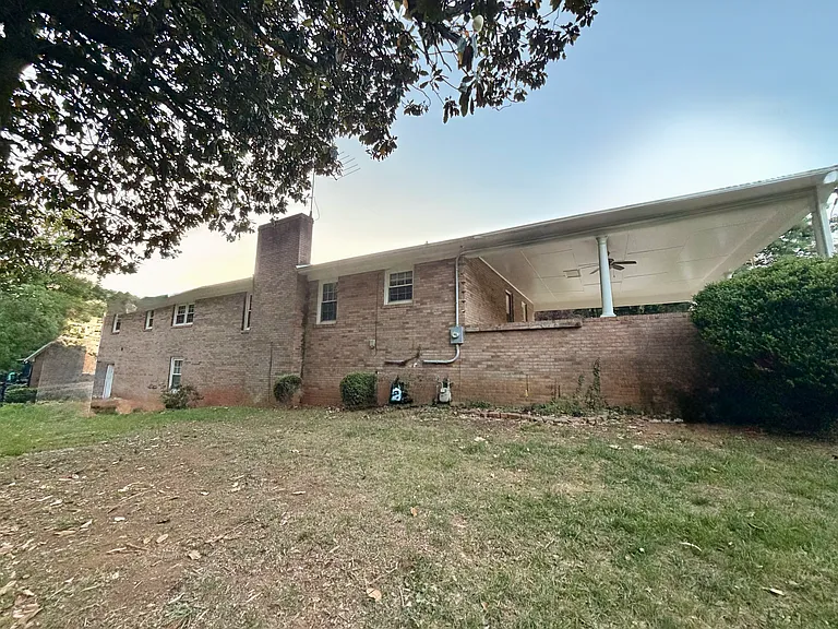 Back of home. Walk in basement