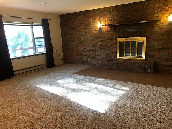 Spacious living room. Carpet has been professionally cleaned and is in great condition. Fireplace decorative only.