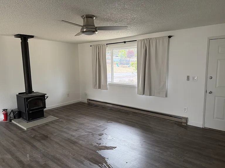 Another view of the living room. Front door to the right. Hallway to all bedrooms is just out of frame to the right.