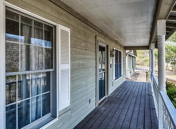 A charming covered front porch welcomes guests