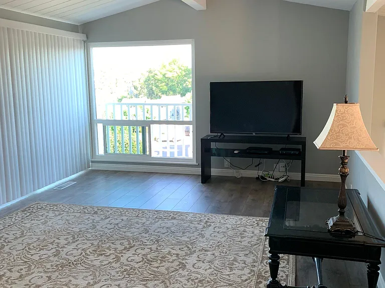 Living room. Carpet & table incl for SDSU students. Large sliding glass door opens to the 2nd balcony.