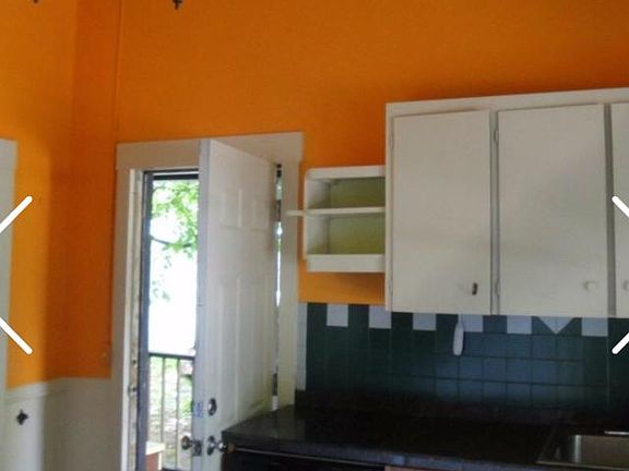 Kitchen(newly painted light yellow). Lots of large windows a