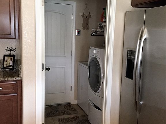 Laundry room off kitchen leading to garage