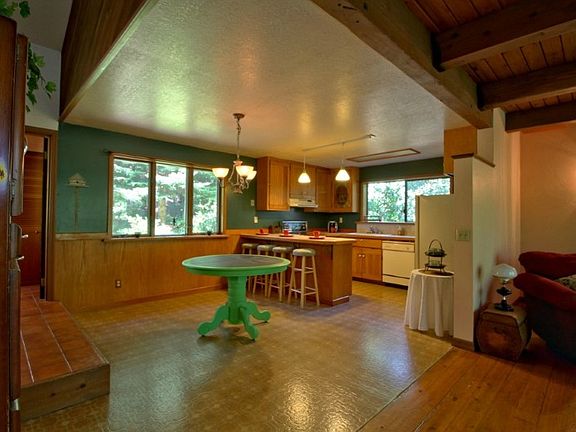 Looking toward dining/kitchen from pellet stove in living room.  Entry and mudroom are up a step to left.