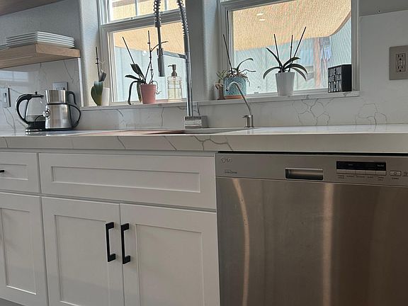 High end sink/faucet/dishwasher. New cabinets. Granite countertop. Floating shelves