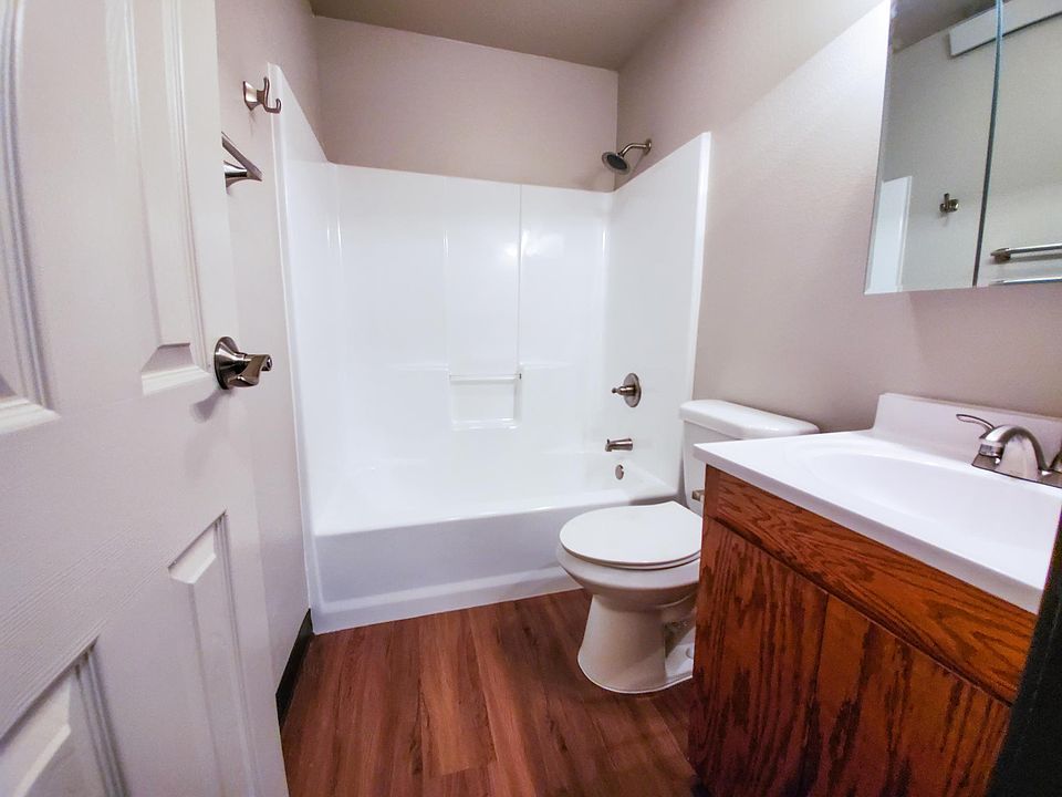 Bathroom with brand new shower and tub, toilet, sink and medicine cabinet.