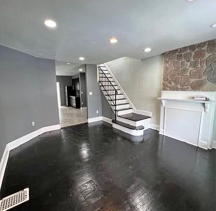 Large living room with all hardwood floors throughout the house.