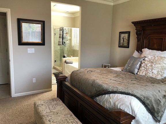 Master bedroom with walk in closet, shower, large tub, and bathroom.
