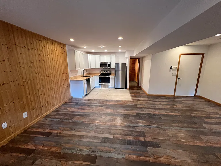 Great room on lower level with kitchen, bathroom entrance and attached garage door!