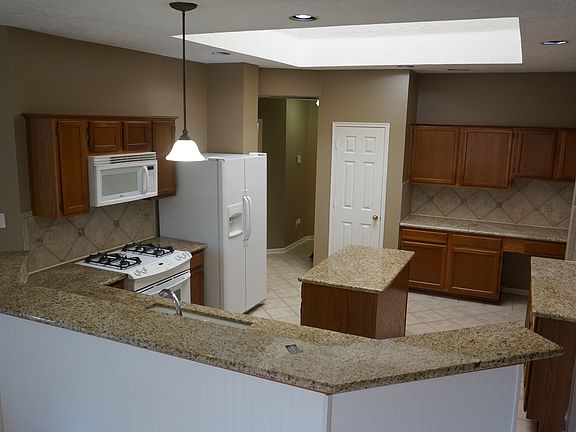 View of the kitchen from the breakfast area and the skylight