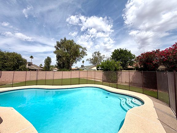 Private backyard oasis featuring a sparkling pool and expansive turf_perfect for relaxing or entertaining.