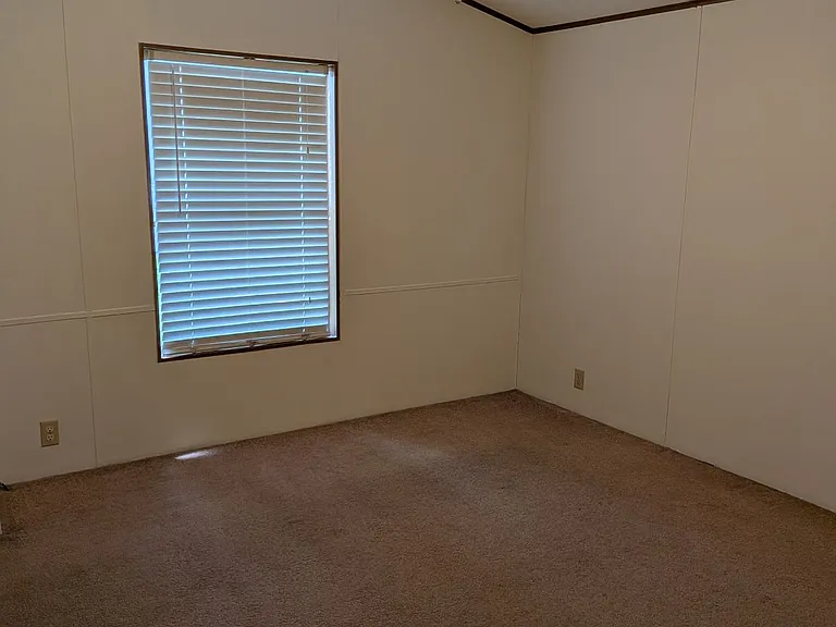 Primary bedroom with ceiling fan, large walk in closet