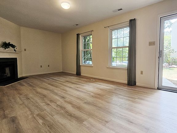 Storm door allows for lots of light in the living room! Wood burning fireplace.