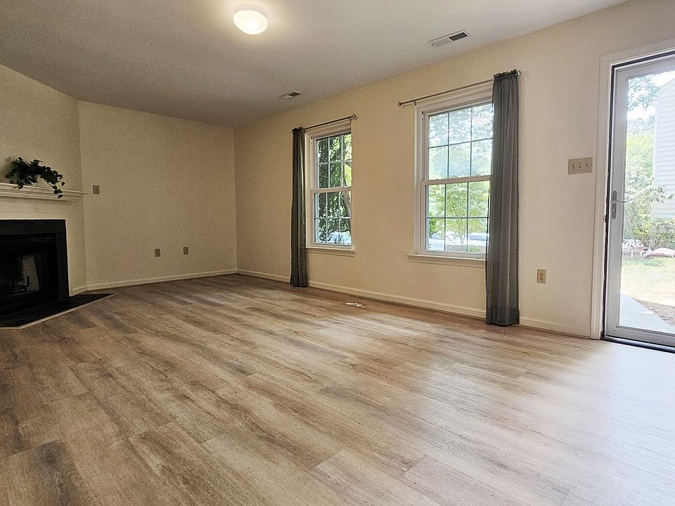 Storm door allows for lots of light in the living room! Wood burning fireplace.