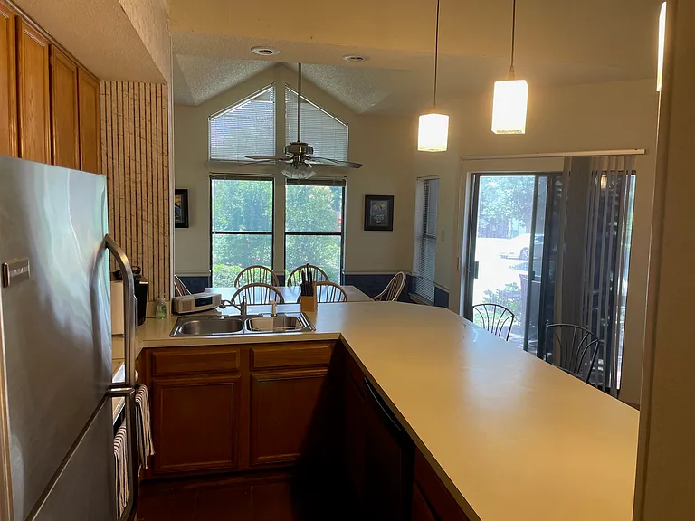Dining room table is just past the countertop with very easy access to kitchen.