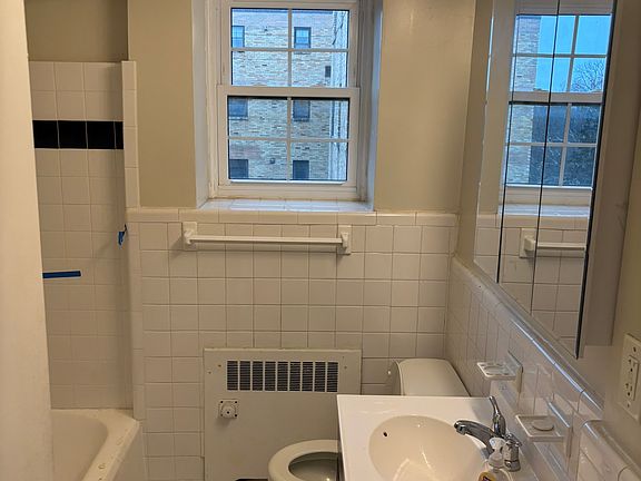 Bathroom with bathtub and washer and dryer