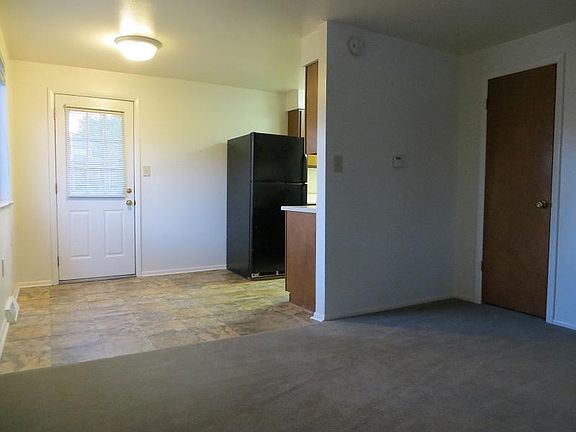 From living room towards dining area, door to backyard and kitchen. Large storage closet under stairs, on right