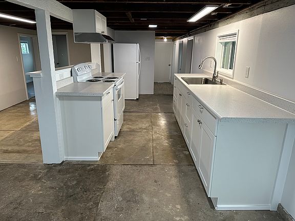 Kitchenette with stove and refrigerator