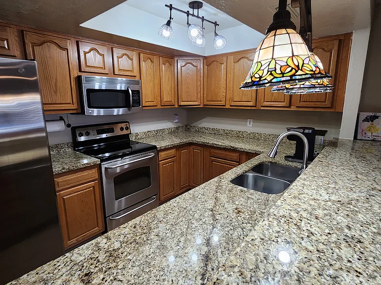 Modern kitchen, appliances and granite countertop.