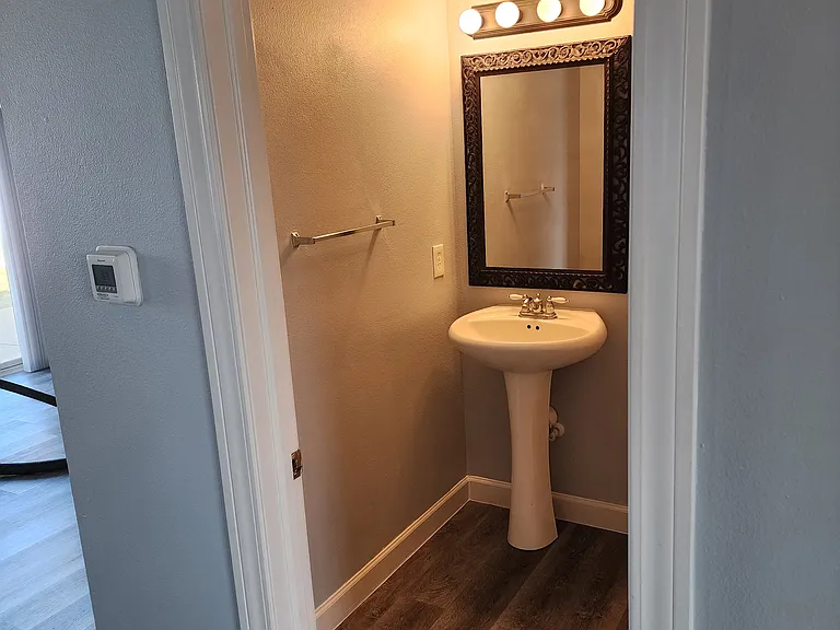 1/2 bath with new mirror, light, and toilet