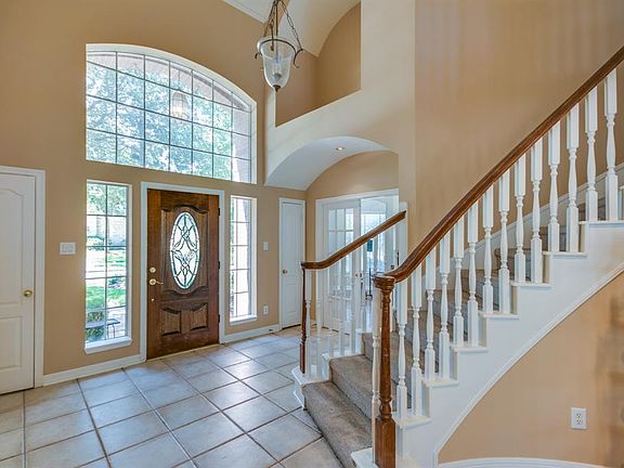 Elegant two story foyer with spiral staircase.