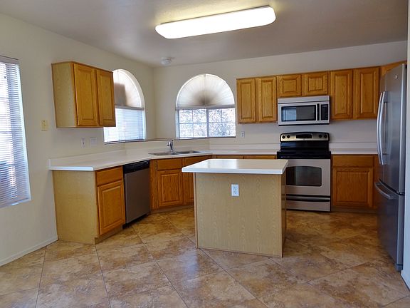Large kitchen with island and new stainless appliances.