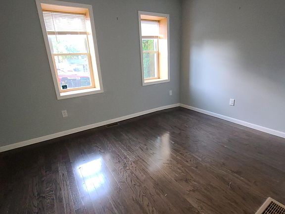Spacious living room with hardwood floors, central air conditioning