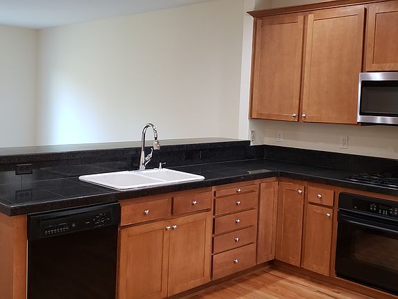 kitchen open to living room, sink, microwave, gas cooktop, oven